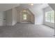 Bright bonus room with neutral colors and carpet, ideal for a playroom, media room, or home office at 140 Maranatha Trl, Lawrenceville, GA 30045
