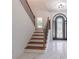 Elegant foyer with a staircase, marble flooring, and a stunning wrought iron front door at 140 Maranatha Trl, Lawrenceville, GA 30045