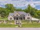 Charming brick home featuring well-kept front lawn, elegant fence, and a welcoming entrance gate at 140 Maranatha Trl, Lawrenceville, GA 30045