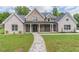 Inviting brick home featuring a stone walkway leading to a covered front porch with stately columns at 140 Maranatha Trl, Lawrenceville, GA 30045