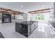 Modern kitchen features an island and black marble countertops and backsplash at 140 Maranatha Trl, Lawrenceville, GA 30045