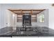 Modern kitchen features an island and black marble countertops and backsplash at 140 Maranatha Trl, Lawrenceville, GA 30045