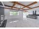 Spacious living room features a fireplace, beamed ceilings, and a kitchen at 140 Maranatha Trl, Lawrenceville, GA 30045