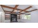 Spacious living room featuring coffered ceilings, fireplace, custom built-ins, and bright windows at 140 Maranatha Trl, Lawrenceville, GA 30045