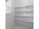 Walk-in pantry featuring white shelves and marble flooring at 140 Maranatha Trl, Lawrenceville, GA 30045