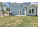 Backyard featuring a large lawn and the exterior of the home with double doors at 212 Birchwood Row, Canton, GA 30115