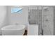 Elegant bathroom featuring a tub and a shower with a glass door at 212 Birchwood Row, Canton, GA 30115