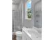 Modern bathroom with double sink vanity, toilet, and a luxurious shower with glass enclosure at 212 Birchwood Row, Canton, GA 30115