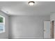 Well-lit bedroom featuring light grey paint and bright windows at 212 Birchwood Row, Canton, GA 30115
