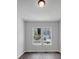 Bright bedroom featuring two windows with neighborhood views and modern hardwood floors at 212 Birchwood Row, Canton, GA 30115