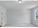 Spacious bedroom with a window and light grey paint at 212 Birchwood Row, Canton, GA 30115