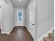 The entryway features wood floors, neutral walls, a staircase, and a glass-paneled front door at 212 Birchwood Row, Canton, GA 30115