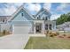 Charming two-story home with light blue siding, white trim, and a well-manicured lawn at 212 Birchwood Row, Canton, GA 30115