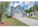 Beautiful home with light blue siding, a spacious driveway, and verdant lawn at 212 Birchwood Row, Canton, GA 30115