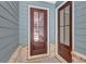 The home has a stylish wooden front door with glass inserts and a brick foundation at 212 Birchwood Row, Canton, GA 30115