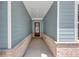 The front porch features an elegant design with a brick foundation and a wooden front door at 212 Birchwood Row, Canton, GA 30115