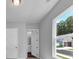 Hallway featuring a view to the bathroom and hardwood floors with white doors and light grey walls at 212 Birchwood Row, Canton, GA 30115
