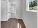 Hallway featuring hardwood floors with white doors and light grey walls at 212 Birchwood Row, Canton, GA 30115