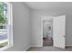 View of a hallway with white doors and hardwood flooring with a view to other rooms of the house at 212 Birchwood Row, Canton, GA 30115