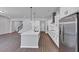 Spacious kitchen featuring white cabinets, a large island, stainless steel appliances, and an open floor plan at 212 Birchwood Row, Canton, GA 30115