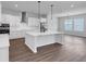 Open concept kitchen with a large island, pendant lighting, and views into the dining area at 212 Birchwood Row, Canton, GA 30115