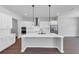 Modern kitchen with quartz countertops, a center island with a sink, and stainless steel appliances at 212 Birchwood Row, Canton, GA 30115