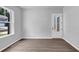 Bright living room with a large window and hardwood flooring at 212 Birchwood Row, Canton, GA 30115