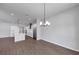 Open concept floor plan with a modern kitchen that flows into a living area with hardwood floors at 212 Birchwood Row, Canton, GA 30115