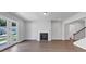 The living room features hardwood floors, a fireplace, and double doors for access to the yard at 212 Birchwood Row, Canton, GA 30115