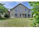Expansive backyard featuring a lush lawn and mature trees that enhance its overall privacy and beauty at 25 Kaktovic Ct, Grayson, GA 30017
