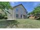 View of a spacious backyard featuring a well maintained lawn and mature trees at 25 Kaktovic Ct, Grayson, GA 30017