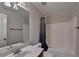 Bright bathroom with white shower-tub combo, white sink and blue shower curtain at 25 Kaktovic Ct, Grayson, GA 30017