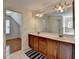 Bright bathroom featuring a double vanity, large mirror and an attached room for extra space at 25 Kaktovic Ct, Grayson, GA 30017