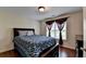 Bedroom featuring hardwood floors, dark wood furnishings, and window with decorative drapes at 25 Kaktovic Ct, Grayson, GA 30017