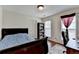 Bedroom with a window, a bookshelf, and a desk with a chair at 25 Kaktovic Ct, Grayson, GA 30017