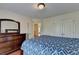 Well-lit bedroom featuring hardwood floors, closet and dresser with mirror at 25 Kaktovic Ct, Grayson, GA 30017