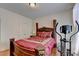 Well-lit bedroom features hardwood floors, ornate bed frame, and exercise machine at 25 Kaktovic Ct, Grayson, GA 30017