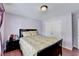 Bedroom featuring wood floors, a queen bed, and a closet with double doors at 25 Kaktovic Ct, Grayson, GA 30017