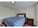 Bedroom with hardwood floors, side table, and bed with blue patterned comforter at 25 Kaktovic Ct, Grayson, GA 30017
