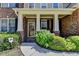 Inviting home entrance with decorative pillars, a tiled porch, and colorful landscaping at 25 Kaktovic Ct, Grayson, GA 30017
