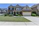 Charming two-story home featuring a brick facade, attached garage, and well-manicured lawn at 25 Kaktovic Ct, Grayson, GA 30017