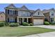 Charming two-story home featuring a brick facade, attached garage, and well-manicured lawn at 25 Kaktovic Ct, Grayson, GA 30017