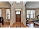 Warm and inviting foyer with hardwood floors, transom window, and views into adjacent rooms at 25 Kaktovic Ct, Grayson, GA 30017