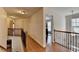 Open hallway with hardwood floors and decorative wrought iron railing at 25 Kaktovic Ct, Grayson, GA 30017