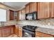 Well-lit kitchen featuring wooden cabinets, granite countertops, and stainless steel appliances at 25 Kaktovic Ct, Grayson, GA 30017