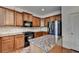 Well-lit kitchen featuring stainless steel appliances, granite countertops, and wood cabinets at 25 Kaktovic Ct, Grayson, GA 30017