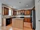 Modern kitchen features stainless steel appliances, granite countertops, and wood cabinets at 25 Kaktovic Ct, Grayson, GA 30017