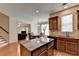 Bright kitchen with granite countertops, wooden cabinets and stainless steel appliances at 25 Kaktovic Ct, Grayson, GA 30017