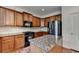 Well-lit kitchen featuring wooden cabinets, granite countertops, a kitchen island, and stainless steel appliances at 25 Kaktovic Ct, Grayson, GA 30017