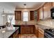 Well-lit kitchen featuring wooden cabinets, granite countertops, and stainless steel appliances at 25 Kaktovic Ct, Grayson, GA 30017